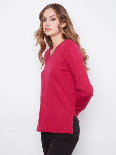 Designed with side slits, this top provides ease of movement and style. Ideal for layering in cooler weather. By Charlie B.