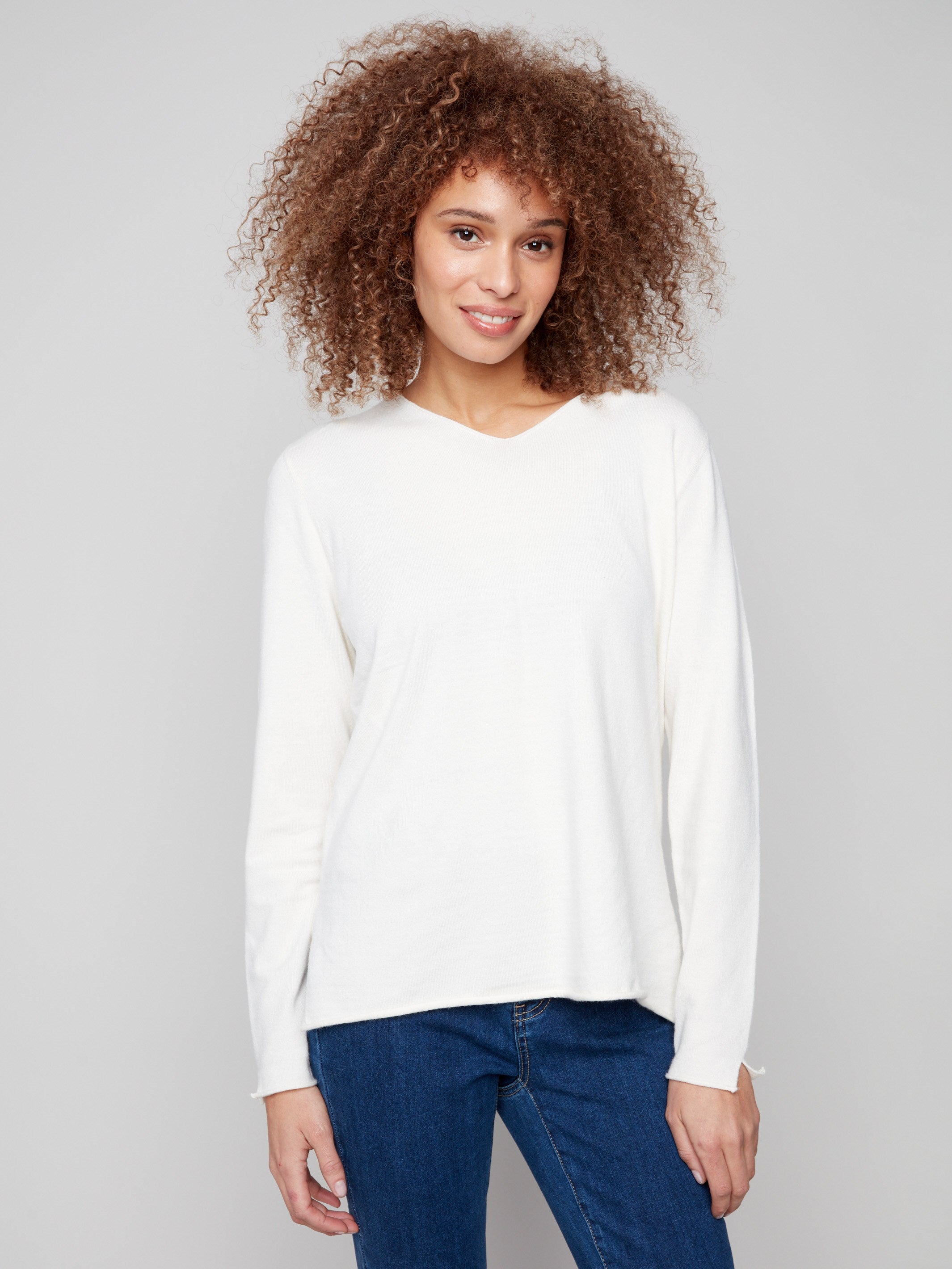 Ecru sweater with plush texture, featuring a V neckline and long sleeves. Classic fit adds to its timeless appeal by Charlie B.
