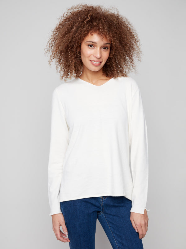 Ecru sweater with plush texture, featuring a V neckline and long sleeves. Classic fit adds to its timeless appeal by Charlie B.