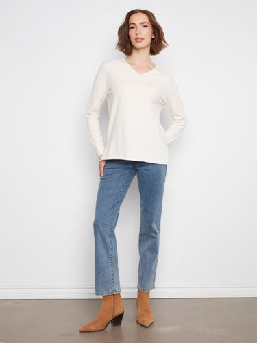 Relaxed fit sweater with long sleeves, ideal for layering in cooler weather. By Charlie B.