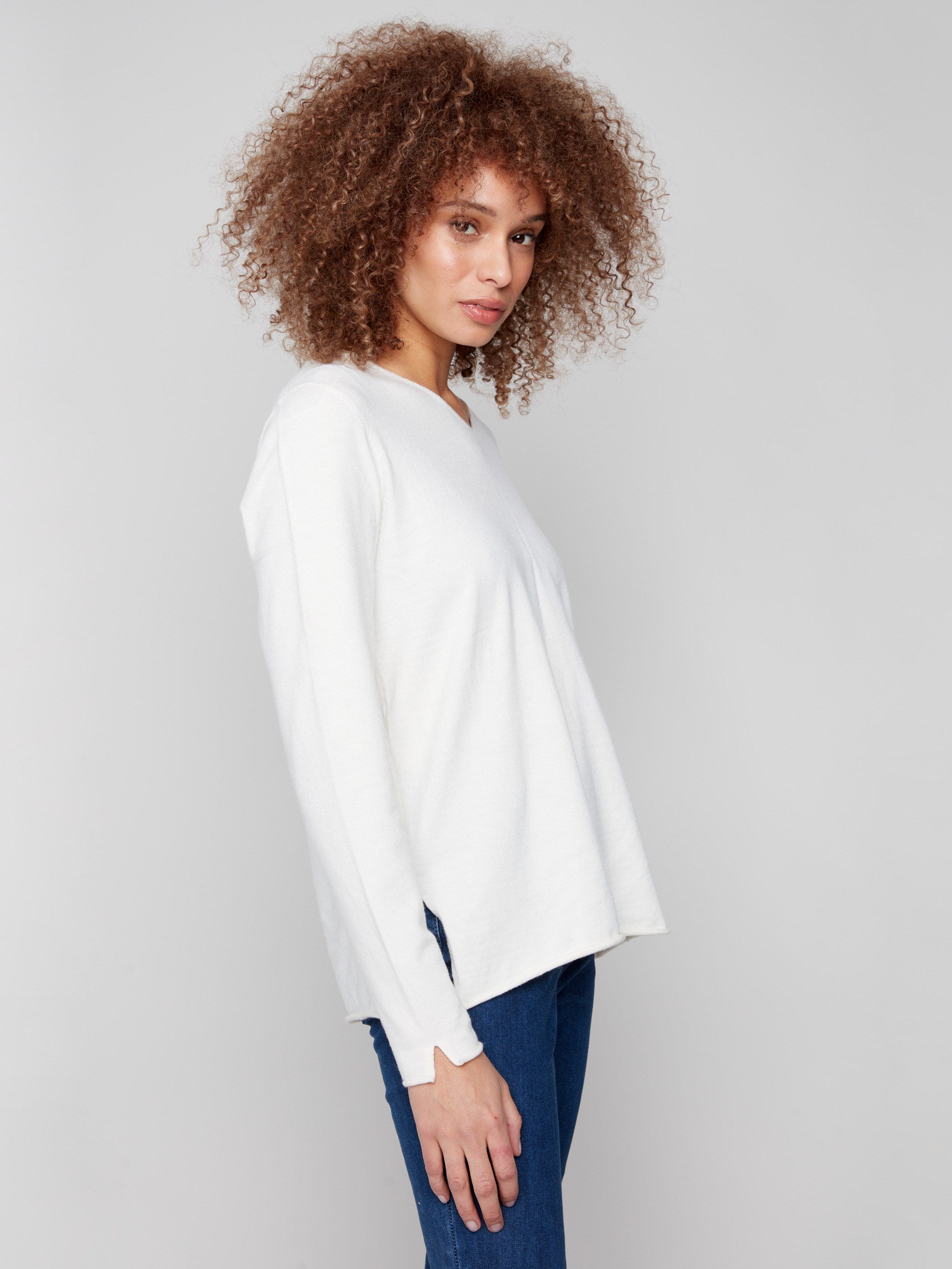 Elegant ecru sweater with side slits on sleeves and hem, offering a relaxed yet stylish look. Perfect for any occasion by Charlie B.