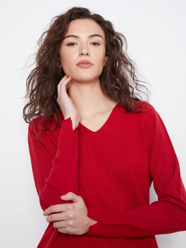 This red top features long sleeves that provide warmth and style, ideal for any casual outing. Designed by Charlie B.