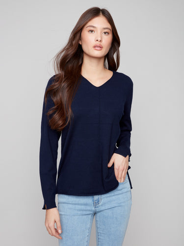 Classic navy sweater with V neckline, perfect for layering or wearing alone for effortless elegance by Charlie B.