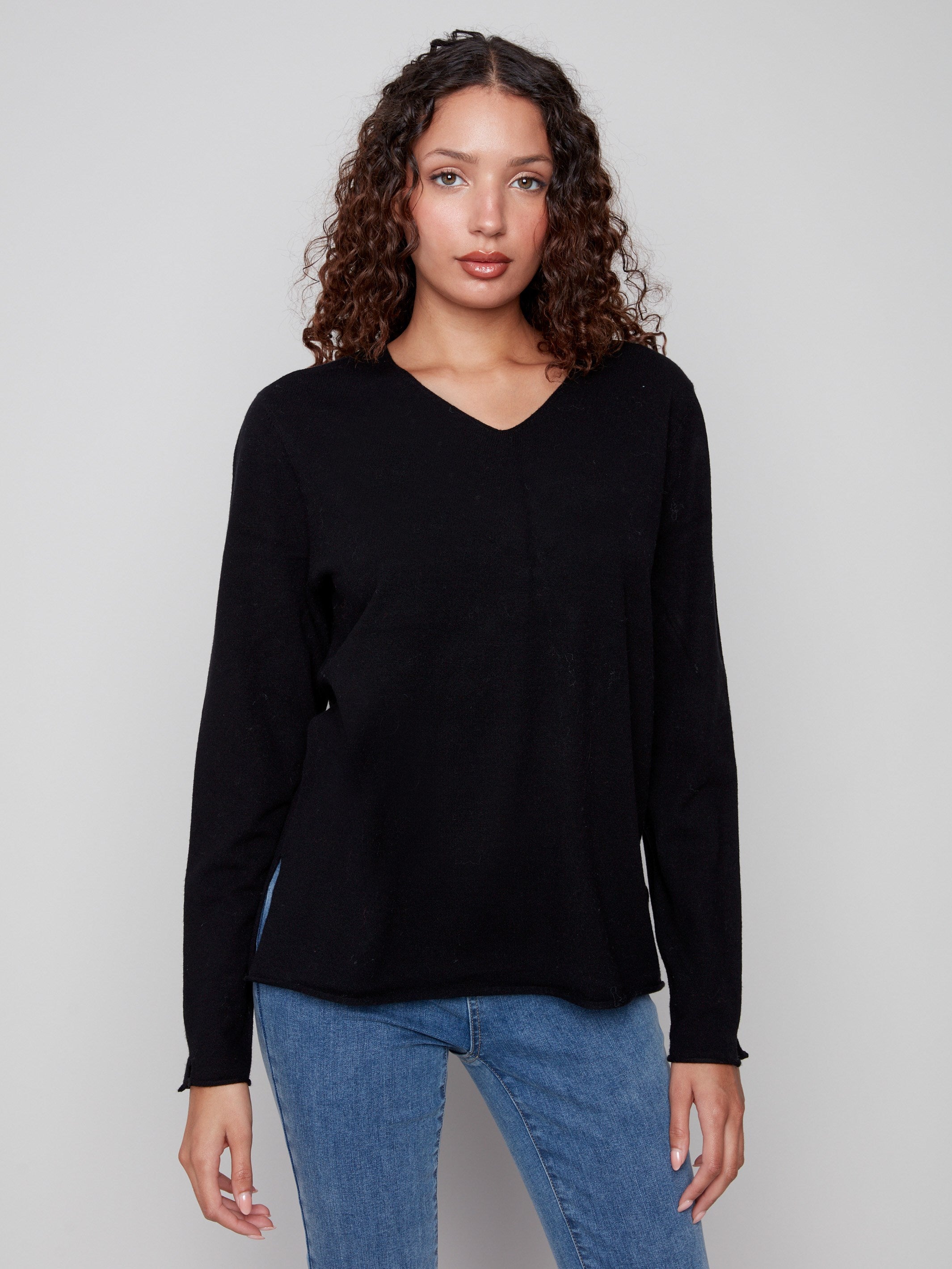 Black sweater with plush texture and refined V neckline, showcasing timeless style by Charlie B.