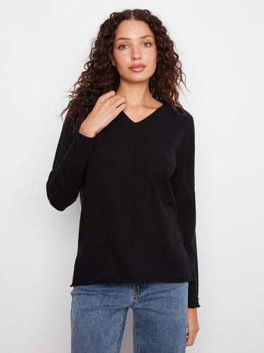 Black sweater designed with long sleeves for versatility by Charlie B.