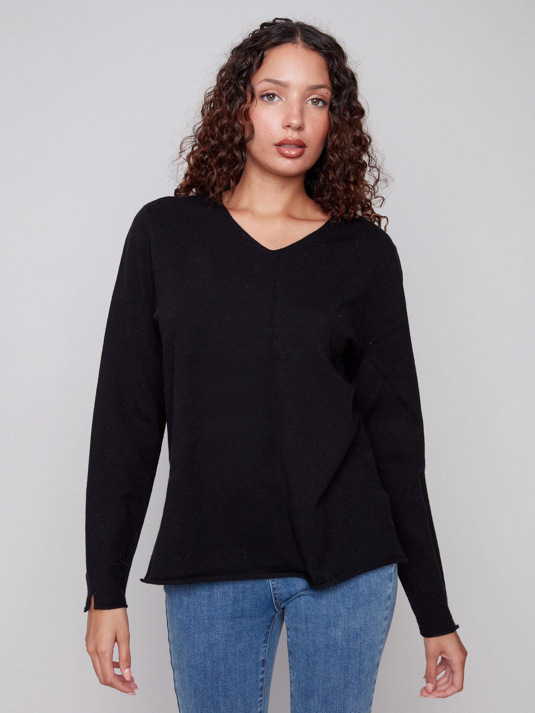 Stylish black V-neck sweater made from plush material, offering comfort and elegance by Charlie B.