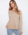 Beige top featuring a soft knit fabric, ideal for cozy days. The V-neckline adds a touch of elegance to the look by Charlie B.