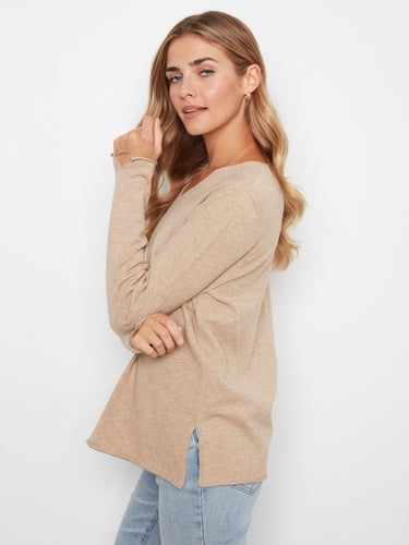 Embrace the soft knit texture of this beige top, ensuring all-day comfort and warmth during chilly days by Charlie B.