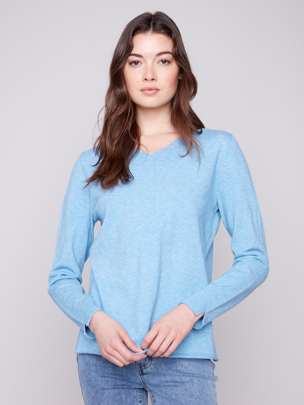 Versatile long-sleeve sweater featuring side slits for added flair and comfort by Charlie B.