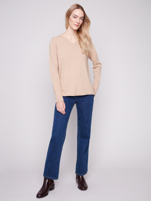 Long-sleeved sesame sweater with side slits on sleeves for added style by Charlie B.