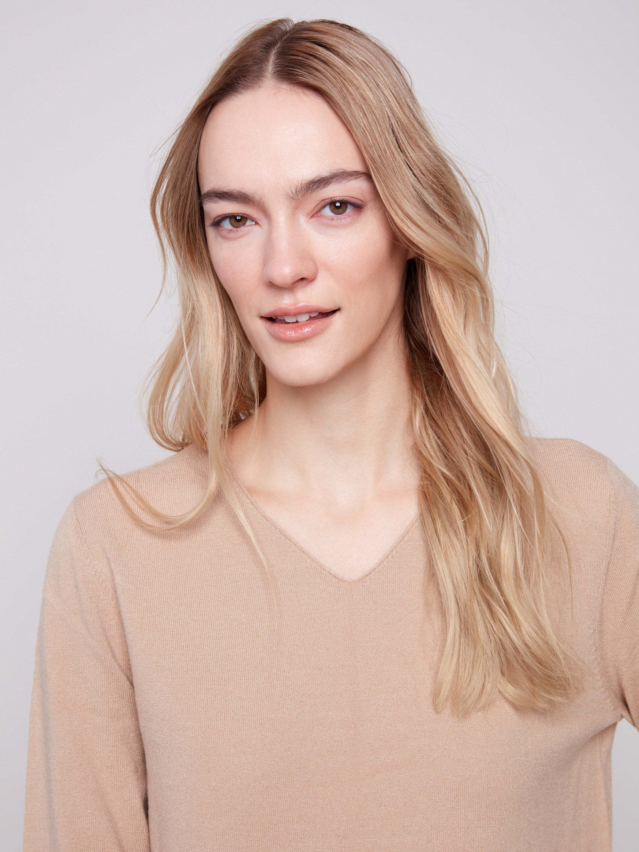 Elegant V-neckline enhances the timeless appeal of this sesame sweater by Charlie B.
