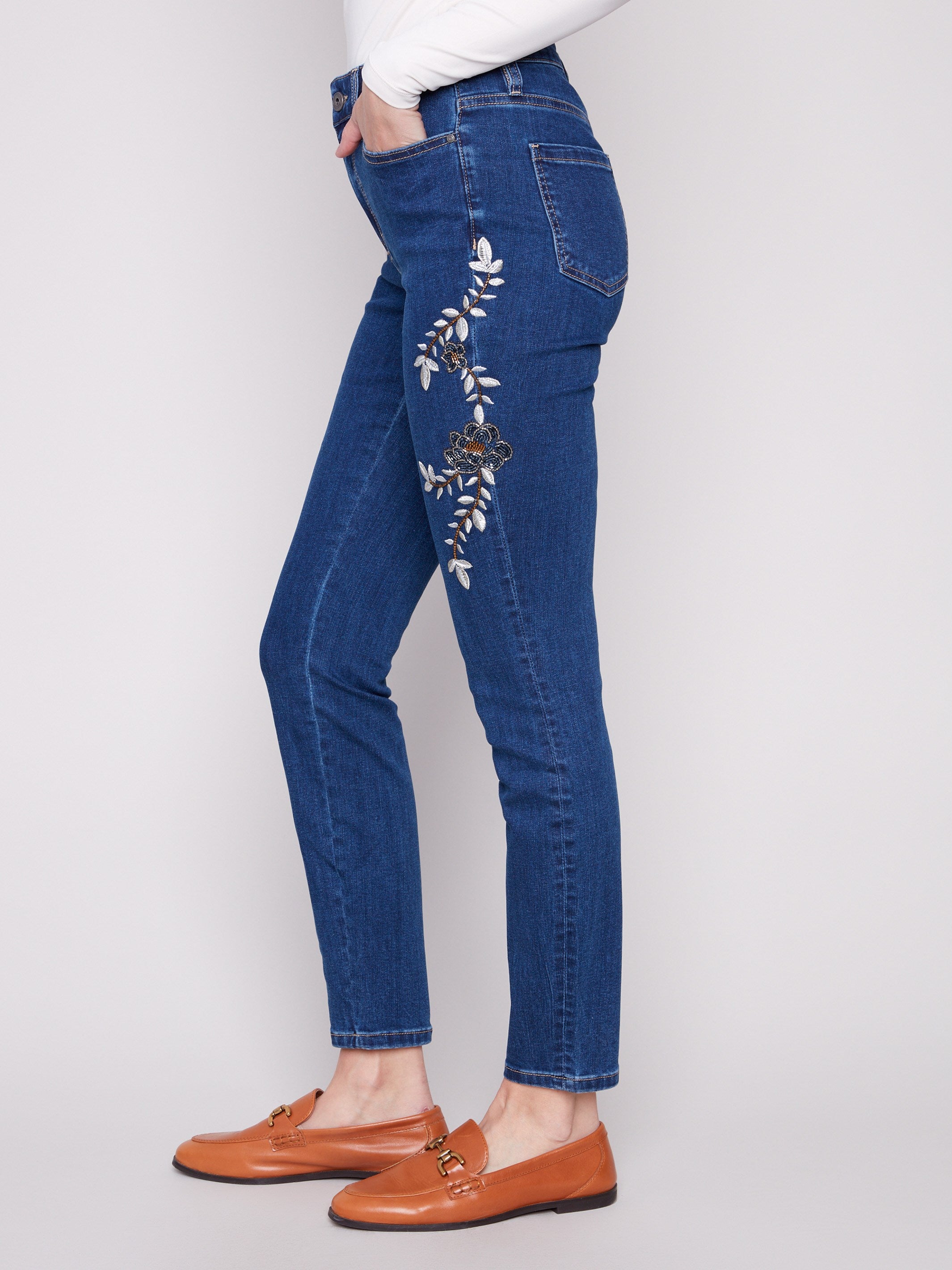 Regular rise indigo denim with five-pocket style and exquisite beaded details along the legs by Charlie B.