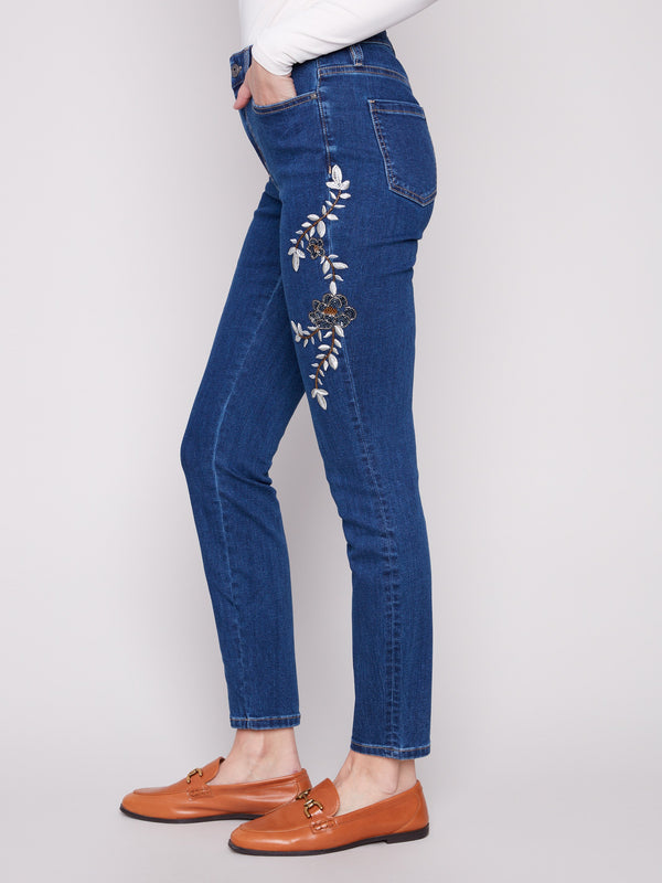 Regular rise indigo denim with five-pocket style and exquisite beaded details along the legs by Charlie B.