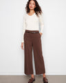 Brown wide leg crepe pants with a cropped length, styled elegantly with a white top by Charlie B.