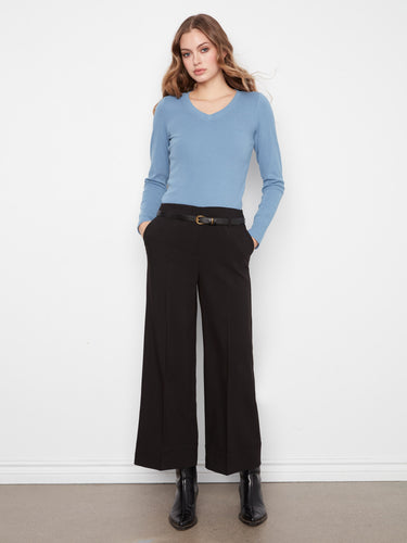 Crafted from stretch crepe fabric, these pants ensure ease of movement while maintaining elegance. By Charlie B.
