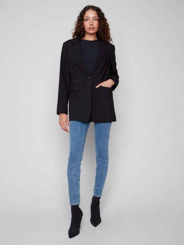 Black blazer featuring a tailored design and single-button closure, perfect for a sleek look by Charlie B.