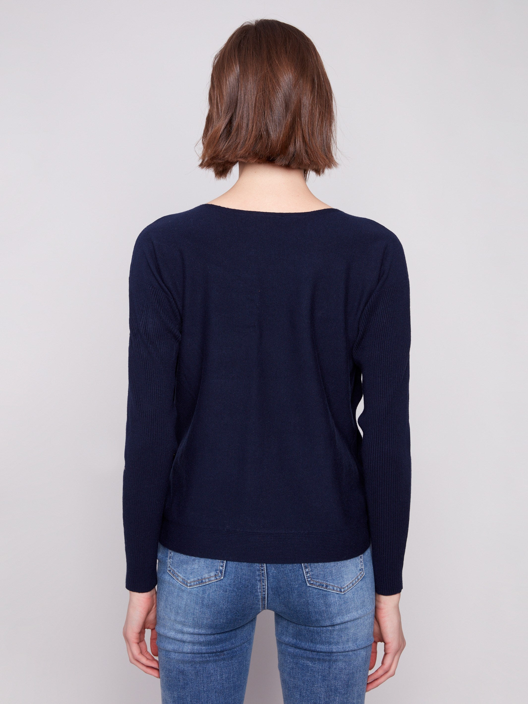 Classic navy sweater designed with ribbed sleeves for added texture and style by Charlie B.