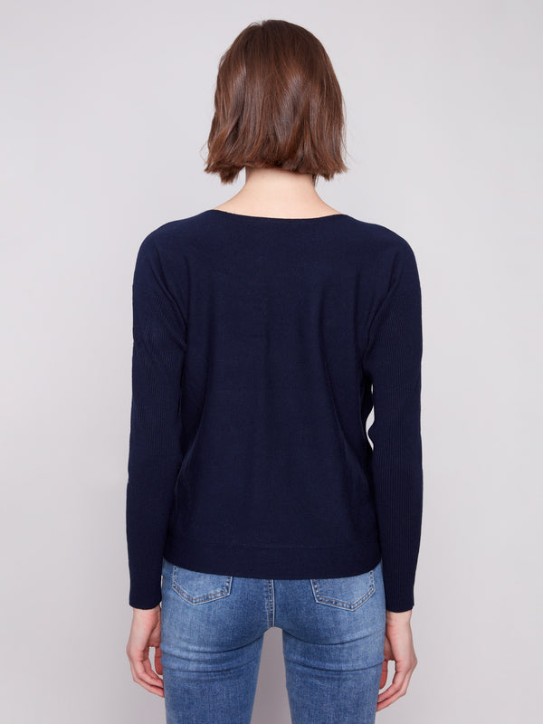 Classic navy sweater designed with ribbed sleeves for added texture and style by Charlie B.