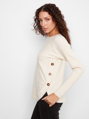 Elegant cream sweater with distinctive side button details, adding a touch of sophistication by Charlie B.