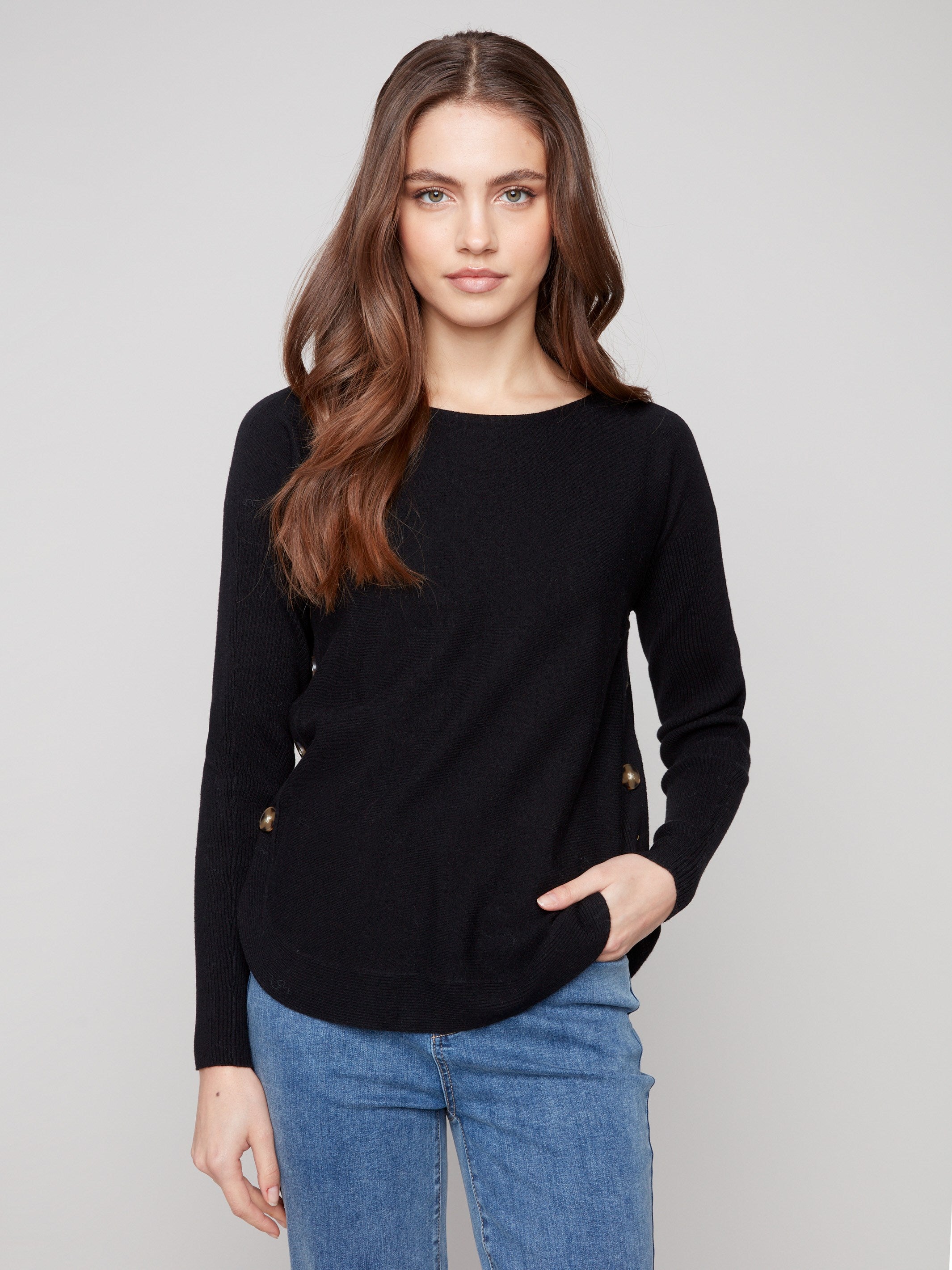 Elegant black sweater featuring a boat neck design, ideal for versatile styling by Charlie B.