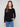 Elegant black sweater featuring a boat neck design, ideal for versatile styling by Charlie B.