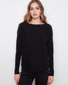 Black long-sleeve sweater with ribbed sleeves and side button detail by Charlie B.