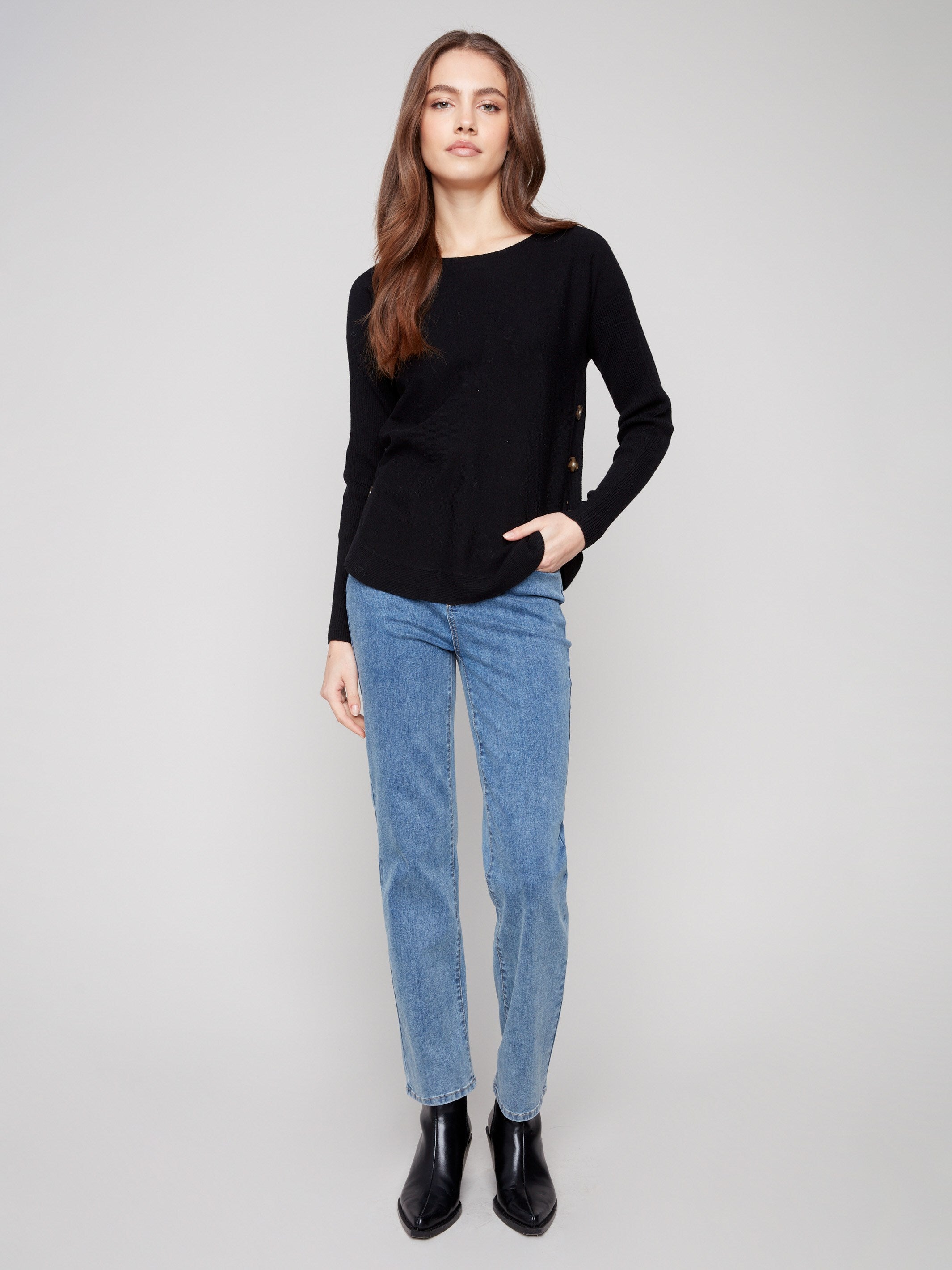 Chic black sweater with side button details, adding a touch of sophistication by Charlie B.