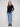 Chic black sweater with side button details, adding a touch of sophistication by Charlie B.