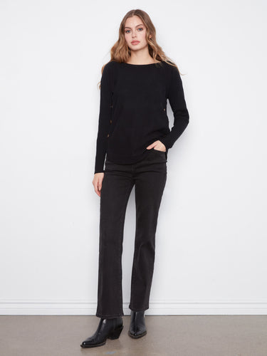 Classic black sweater with boat neck design and side button accents by Charlie B.