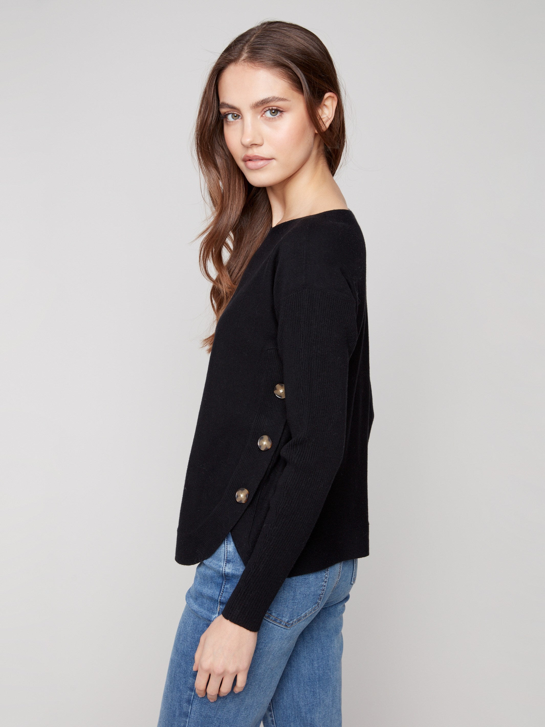 Black long-sleeve sweater showcasing ribbed sleeves for added texture by Charlie B.