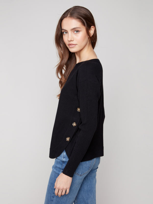 Black long-sleeve sweater showcasing ribbed sleeves for added texture by Charlie B.