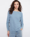 Light blue sweater with a boat neck design, complemented by stylish side button details for added flair. By Charlie B.