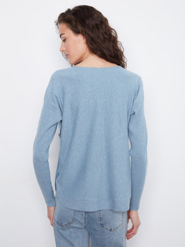 Comfortable light blue sweater highlighting the unique boat neck style paired with trendy ribbed sleeves. By Charlie B.