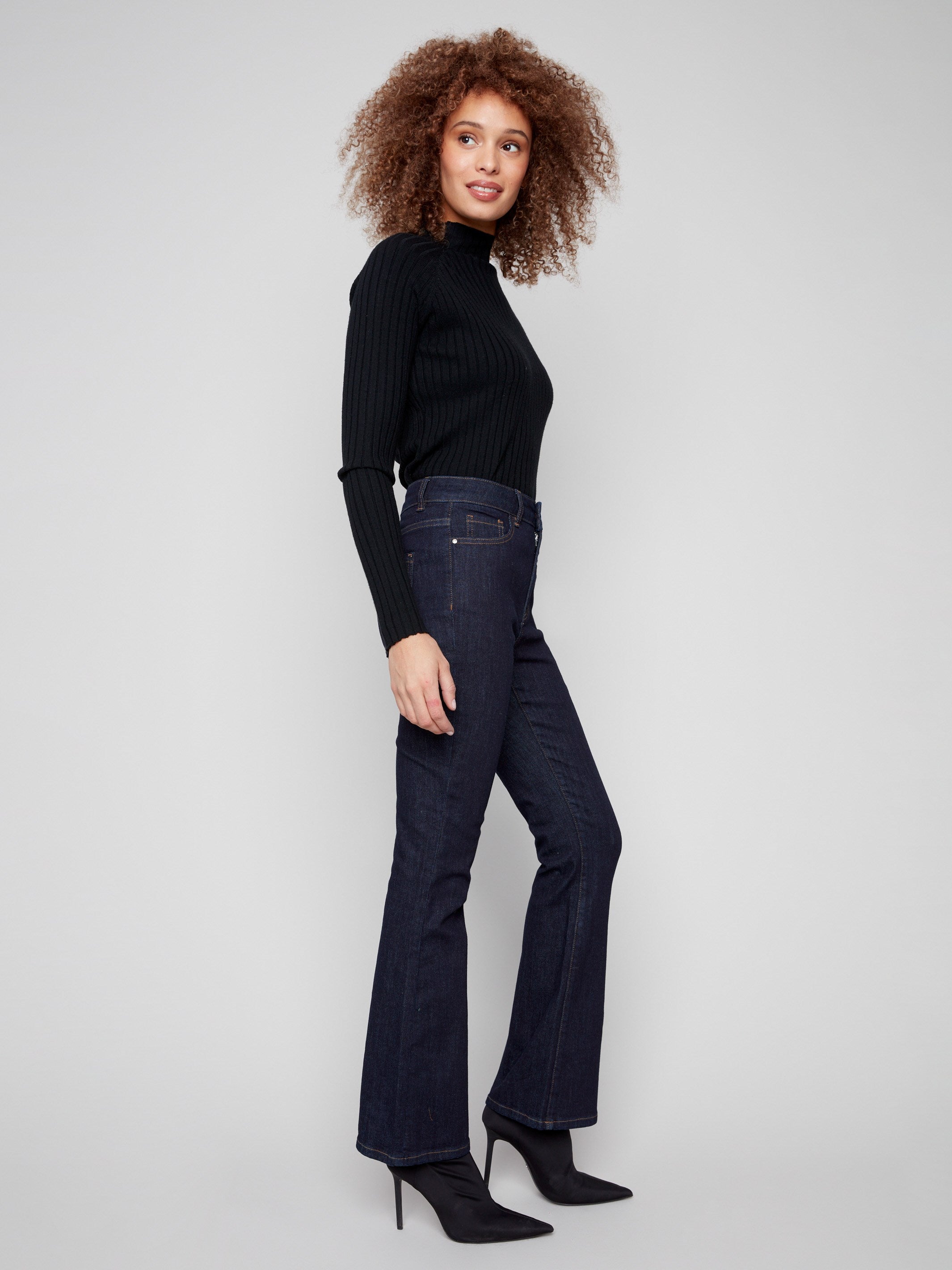 Classic five-pocket design adds functionality to these chic deep blue jeans by Charlie B.