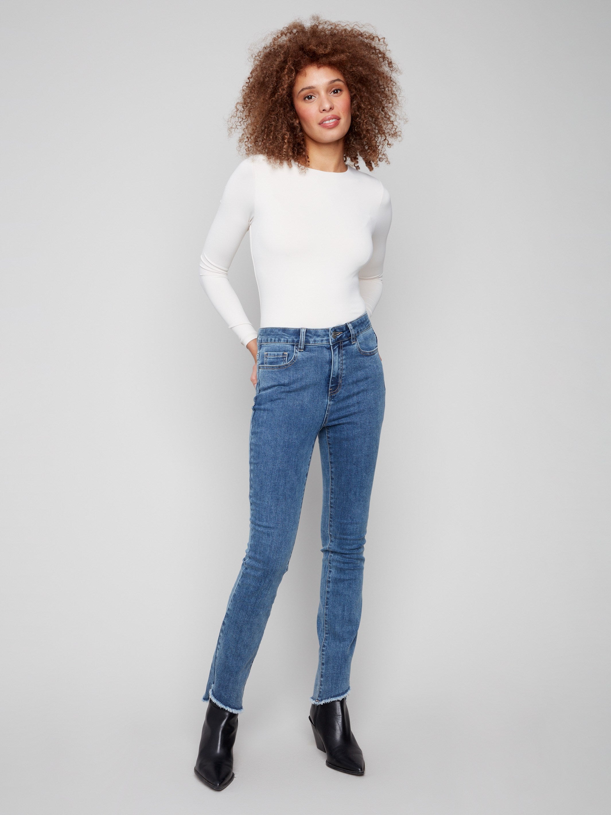 Medium blue jeans featuring a classic bootcut fit, perfect for versatile styling by Charlie B.