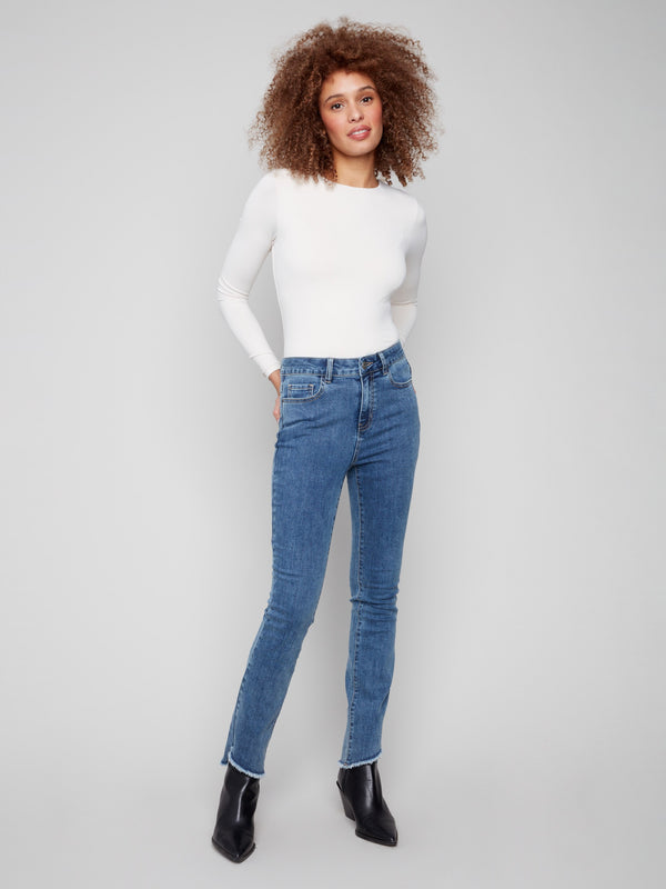 Medium blue jeans featuring a classic bootcut fit, perfect for versatile styling by Charlie B.