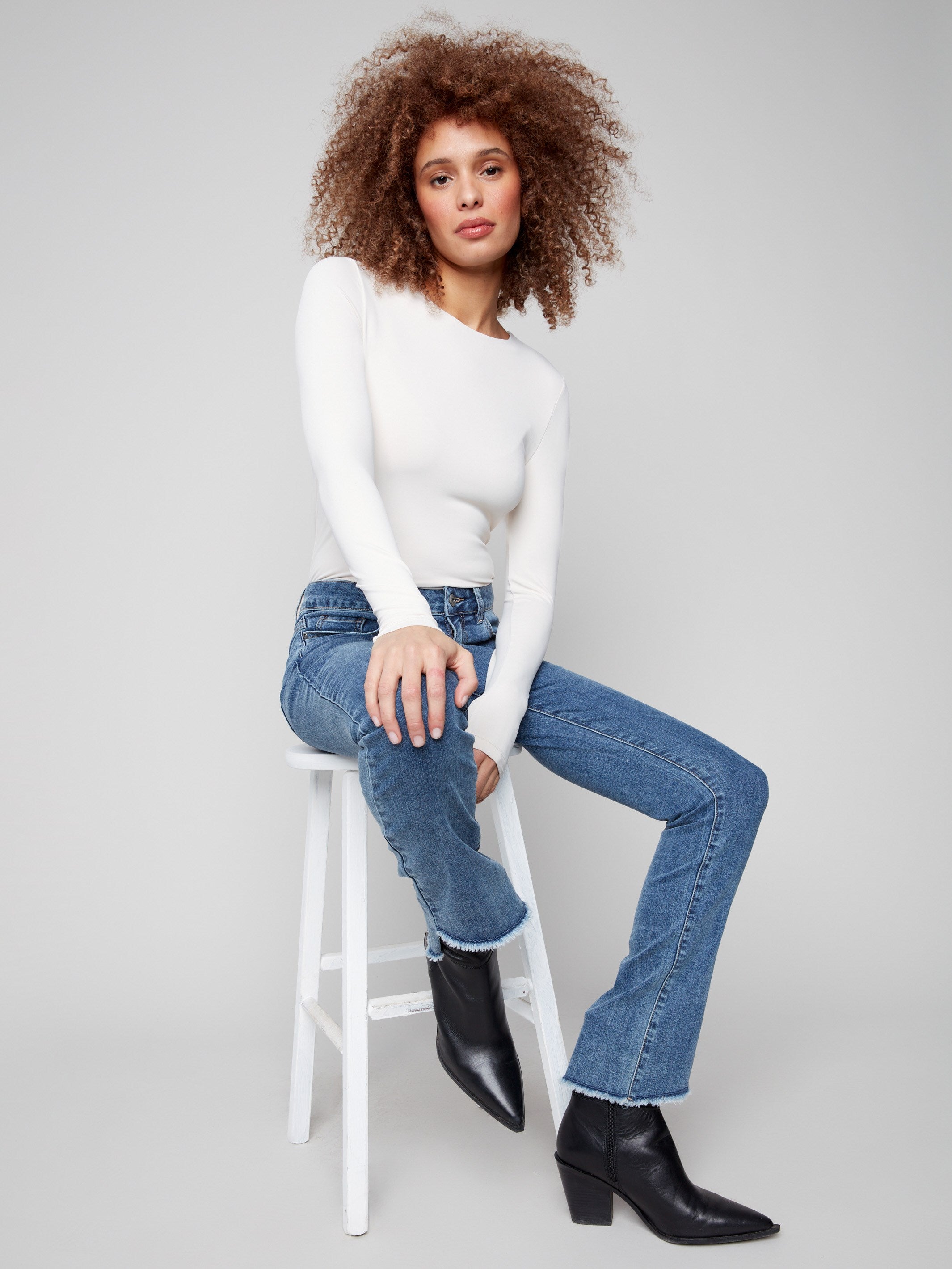 Long length bootcut jeans in medium blue, designed for a sleek silhouette by Charlie B.