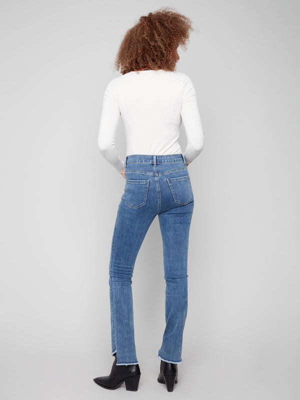 Medium blue jeans with an asymmetrical fringed hem for a trendy touch by Charlie B.