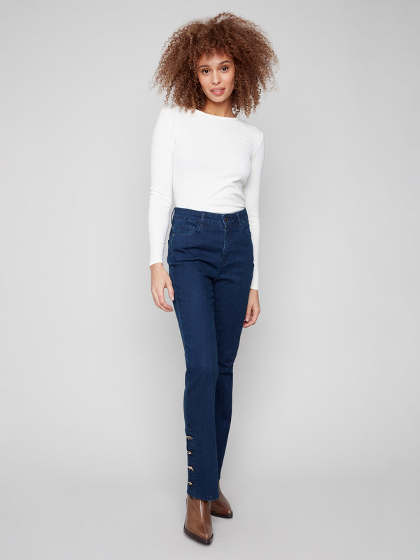 Blue-black jeans crafted from stretch denim material, offering a comfortable bootcut fit with stylish gem buttons by Charlie B.