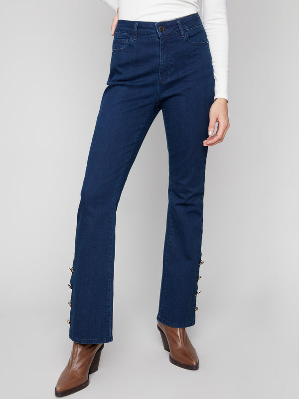 These blue-black jeans feature a regular rise waist and elegant snap gem buttons at the hem for added flair by Charlie B.