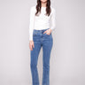 Medium blue bootcut denim pants by Charlie B featuring a stylish mid-rise waist, perfect for everyday wear.