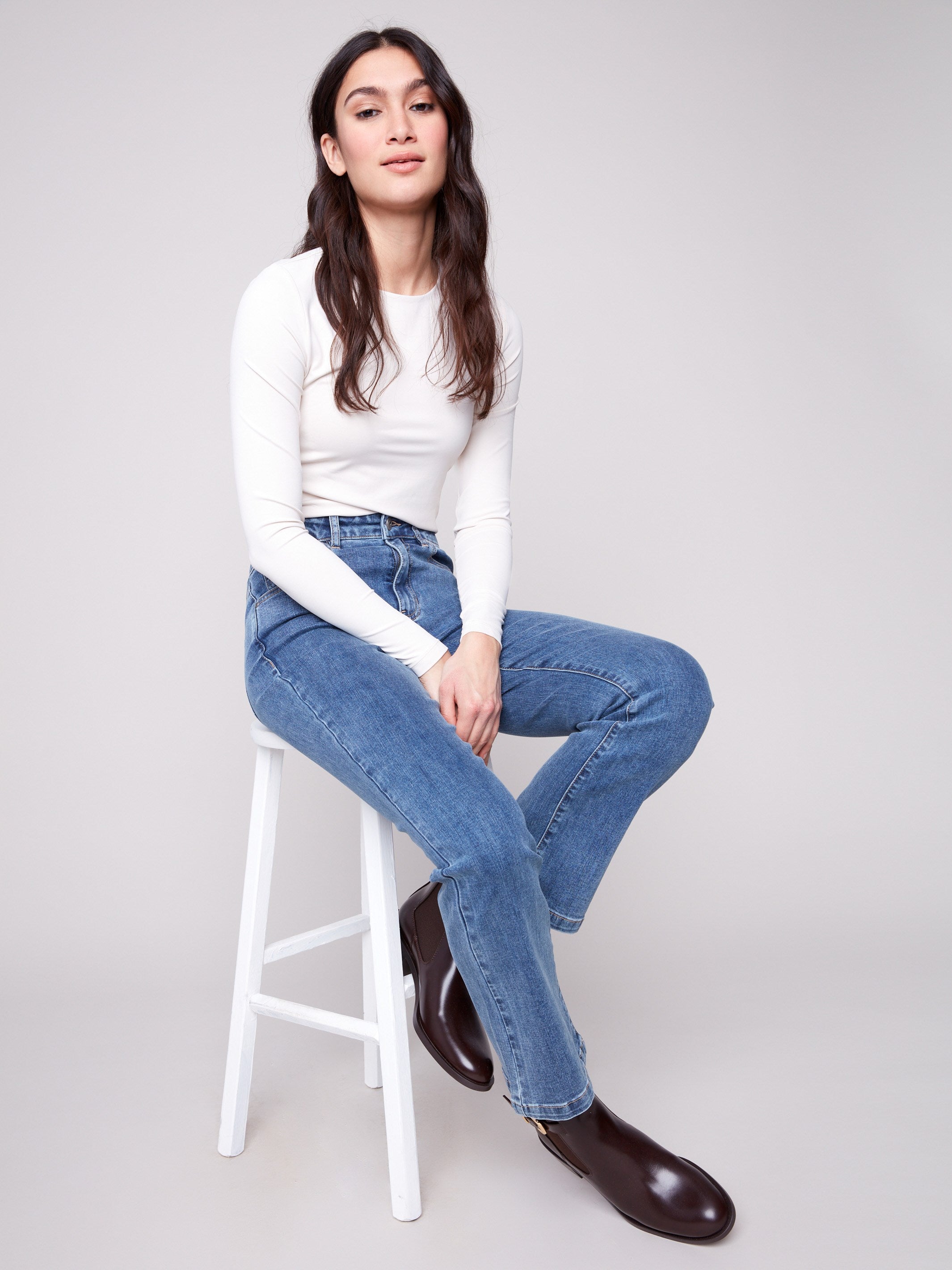 Experience the flattering bootcut fit in these versatile medium blue denim pants by Charlie B.