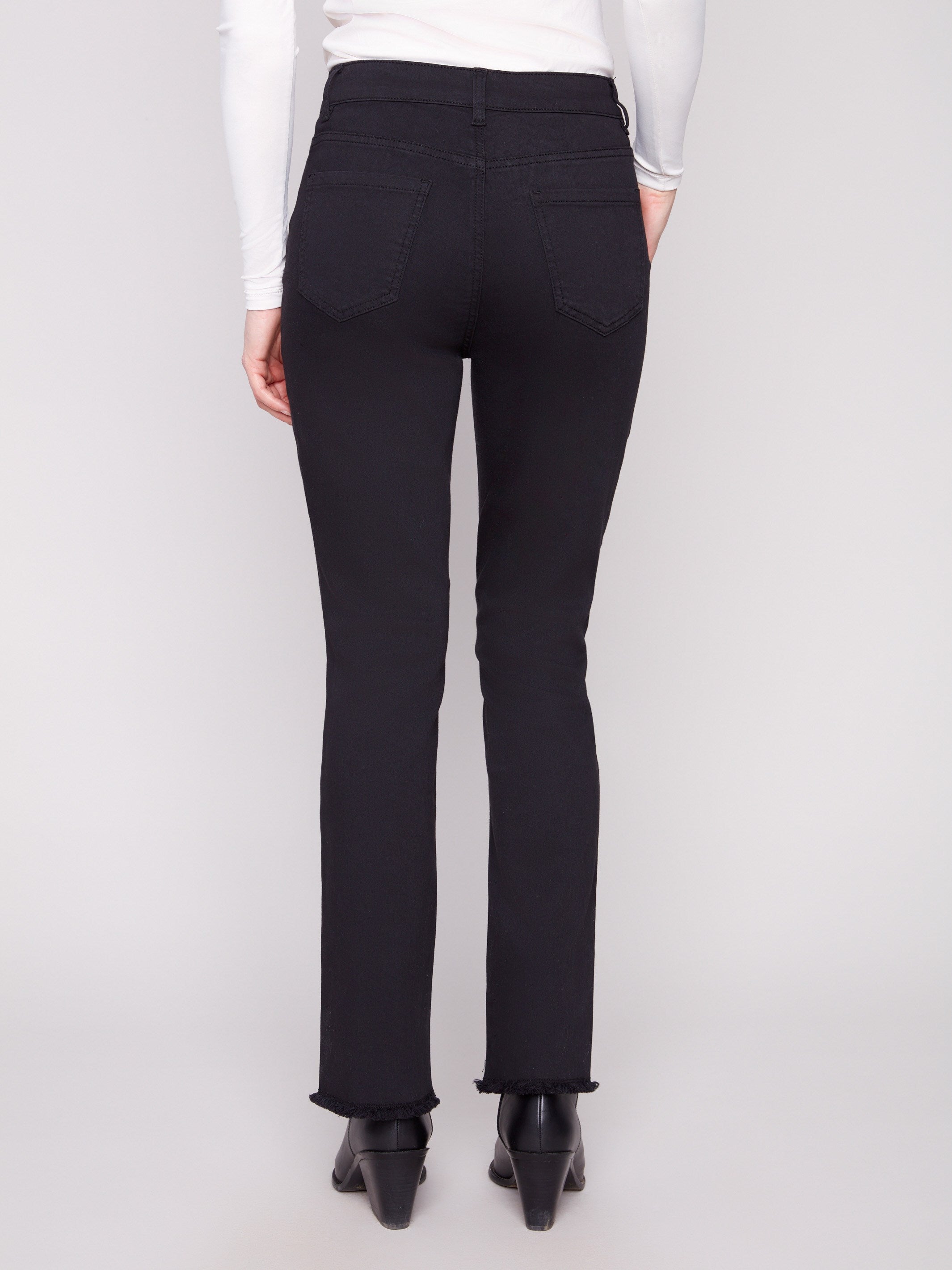 Designed with a classic five-pocket style, these black twill pants offer functionality and fashion by Charlie B.