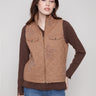 Khaki quilted vest with a sleek zip front closure, featuring stylish boucle star accents for a unique touch by Charlie B.