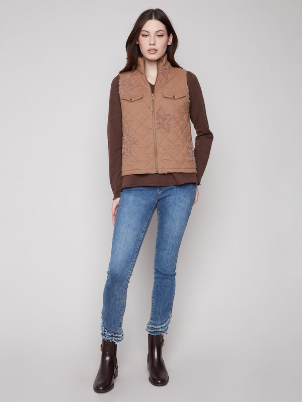 This khaki vest showcases chic welt pockets and intricate quilting, adding both style and functionality by Charlie B.