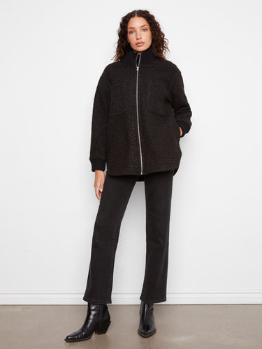 This piece is designed with a ribbed stand collar for added warmth and a chic look. By Charlie B.