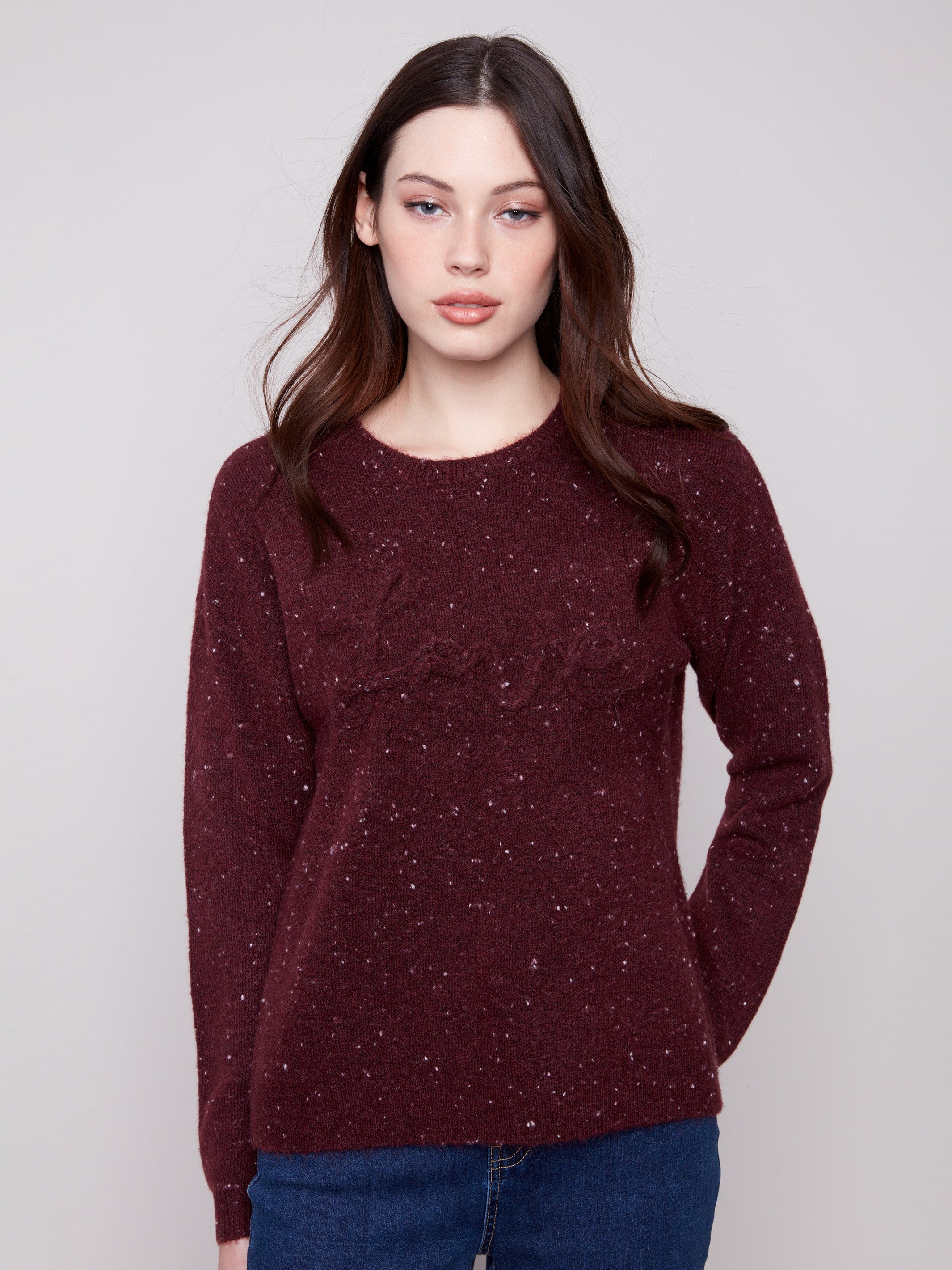 Cabernet sweater with a speckled pattern, showcasing long sleeves and a chic braided 'Love' detail on the front by Charlie B.