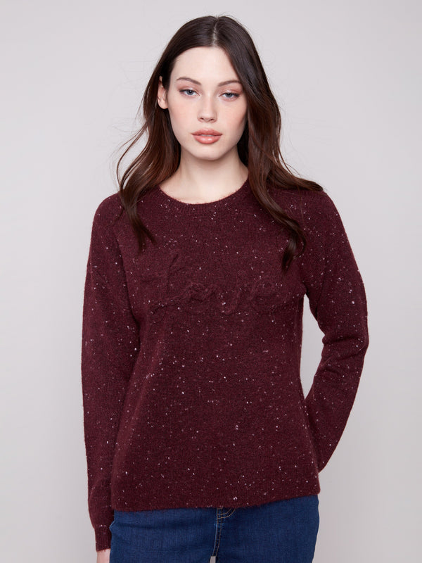 Cabernet sweater with a speckled pattern, showcasing long sleeves and a chic braided 'Love' detail on the front by Charlie B.