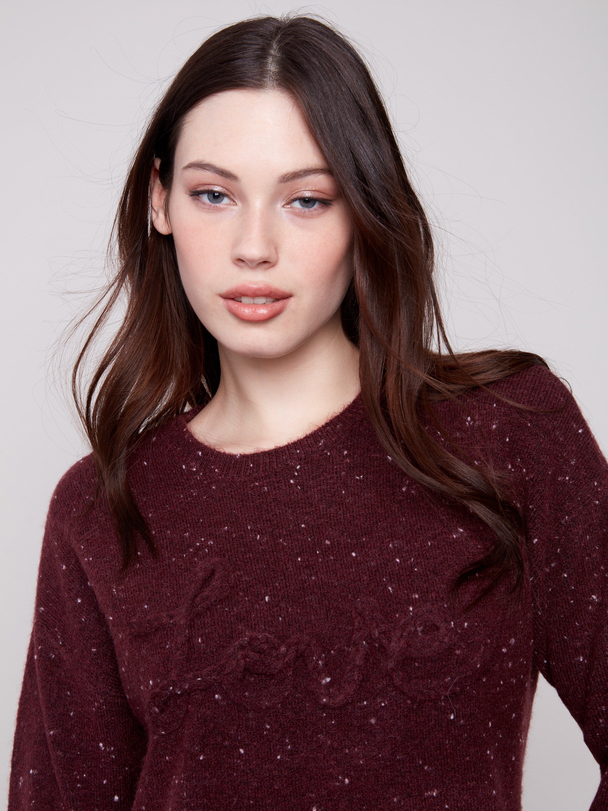 Stylish cabernet sweater featuring a crew neck and elegant speckled pattern, accentuated by the unique braided 'Love' detail by Charlie B.