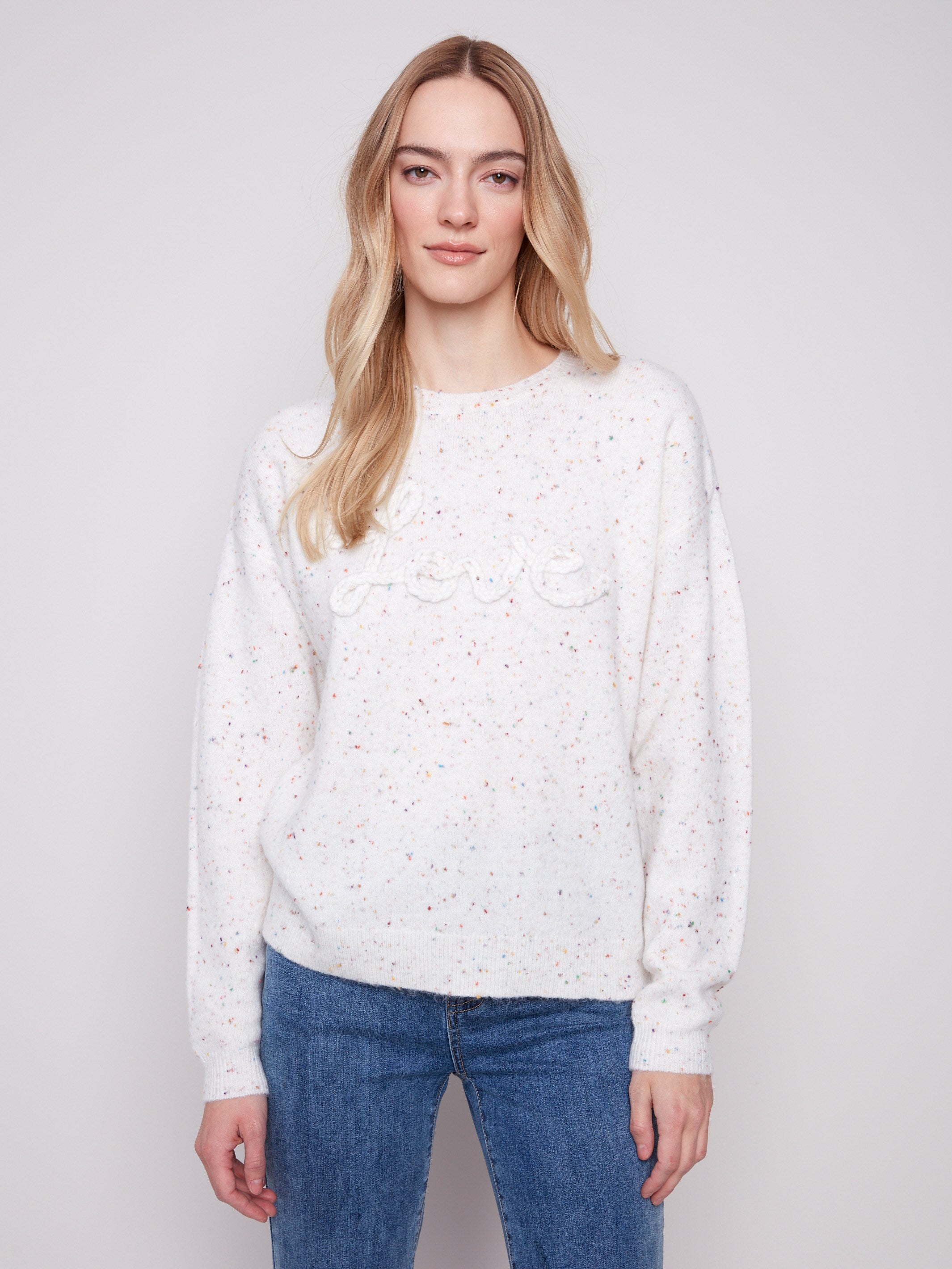 Ecru sweater with a stylish crew neck and speckled design, featuring a unique braided 'Love' detail on the front by Charlie B.